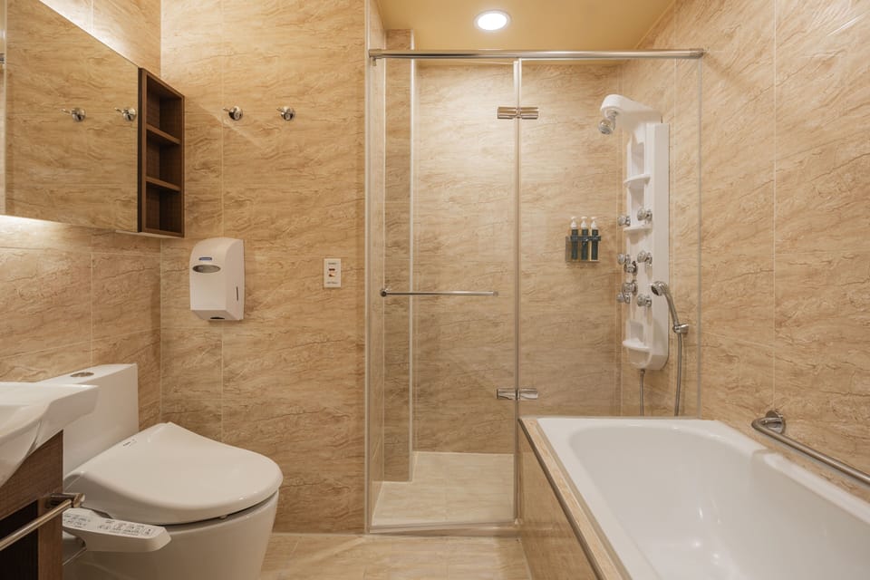 Separate tub and shower, hair dryer, slippers, towels