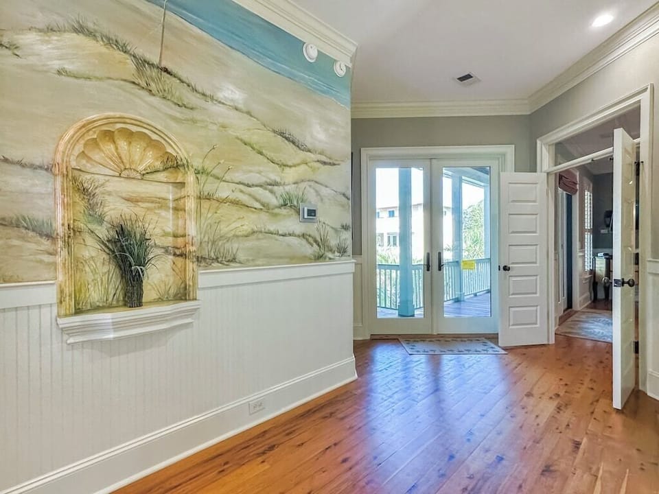 View of wide hallways, hardwood floors.