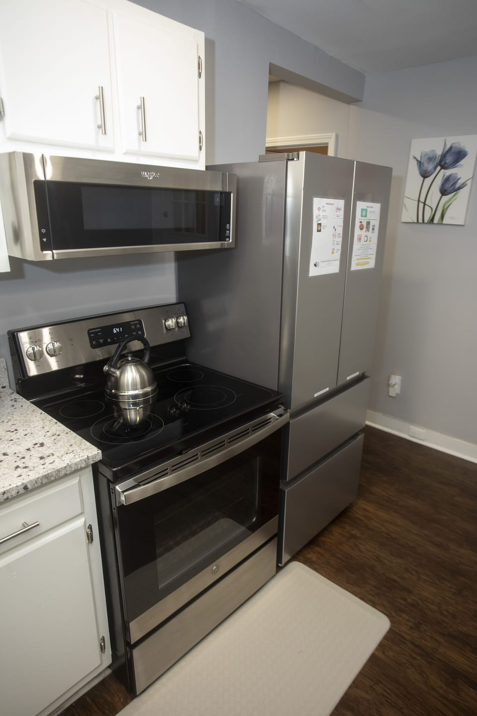 Kitchen also has wood flooring, a granite countertop, a Keurig, and a deep sink.