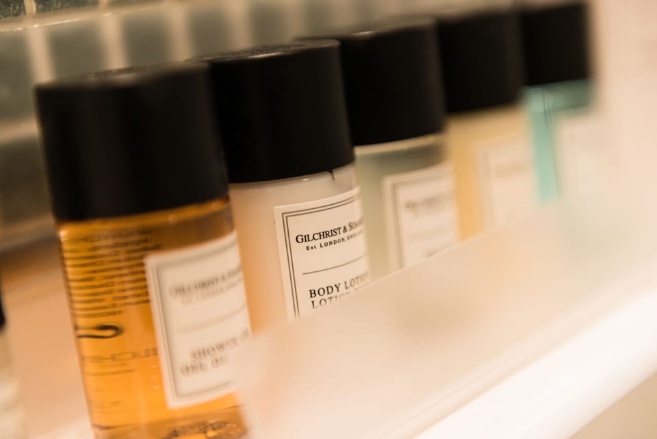 Designer toiletries, hair dryer, towels