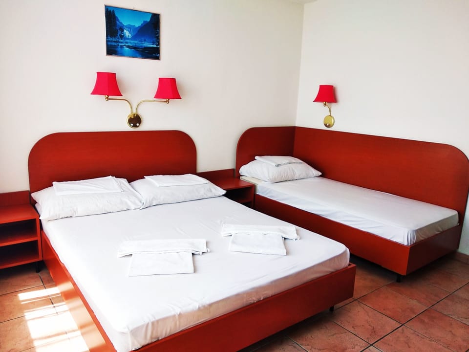 Triple Room | Desk, blackout drapes, free WiFi, bed sheets
