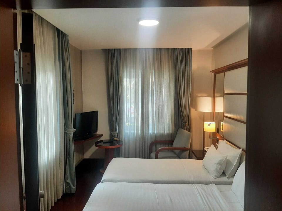 Twin Room | Down comforters, minibar, in-room safe, desk