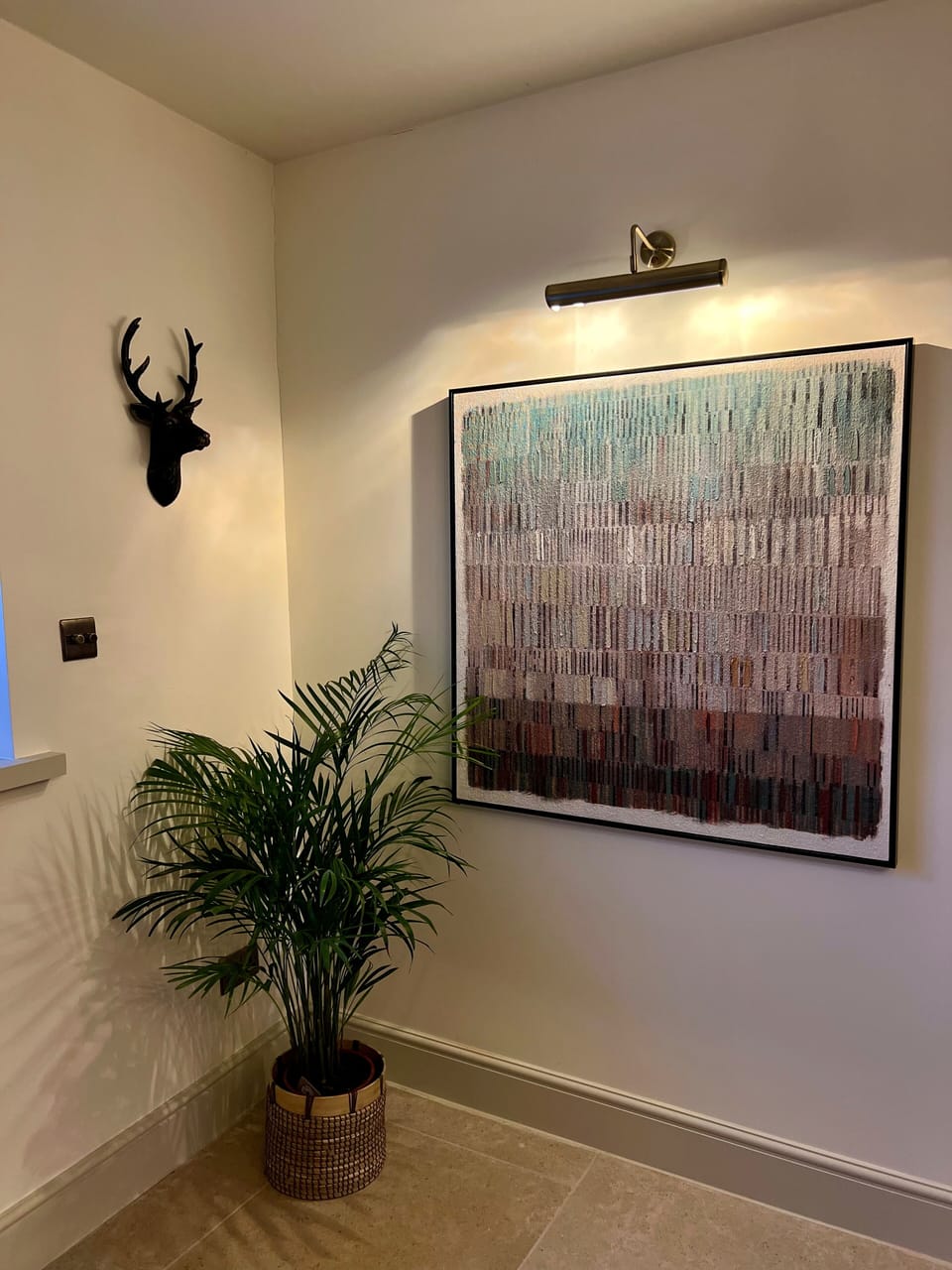 Artwork and plants make the cottage feel warm and inviting 