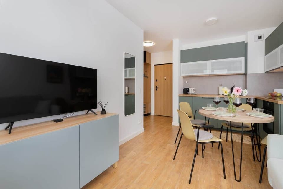 An open-plan living and dining area with modern furniture and bright natural light.

