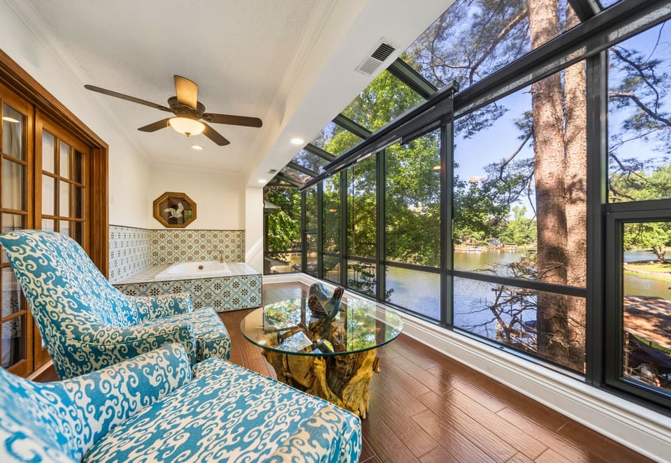 A sunny sitting area beside the windows creates the perfect place to relax with coffee and enjoy the wooded surroundings.