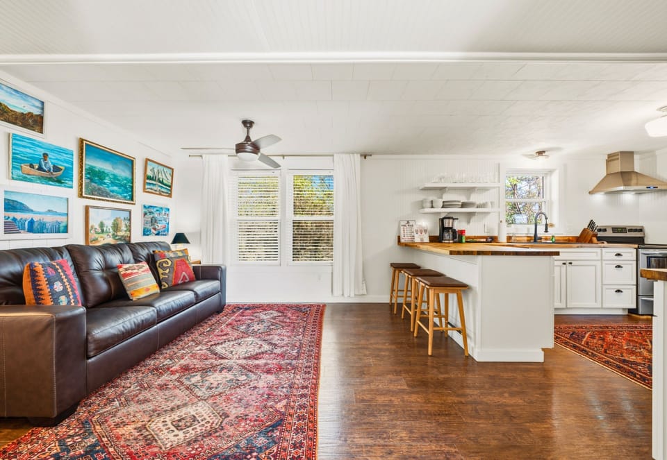 Step inside the guest house living area where comfortable seating and colorful accents create a relaxed and welcoming place to gather.