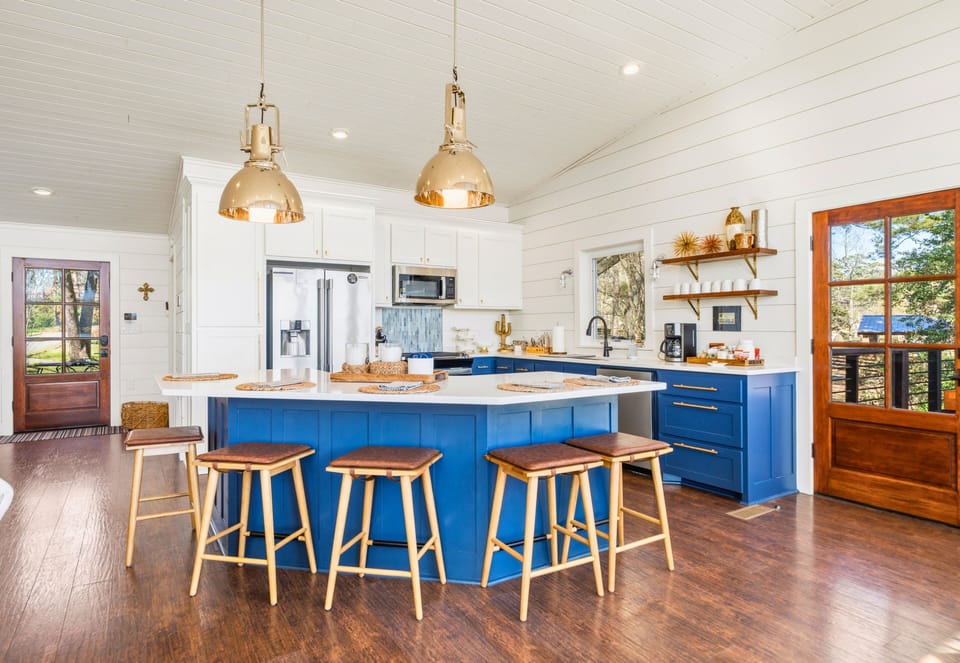 Step into the kitchen where vibrant cabinetry and a spacious layout make cooking both fun and convenient.