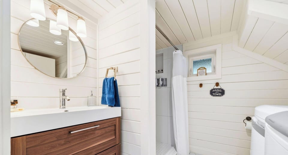 Step into this additional bathroom where clean design and practical features provide everything needed for a smooth and comfortable stay.
