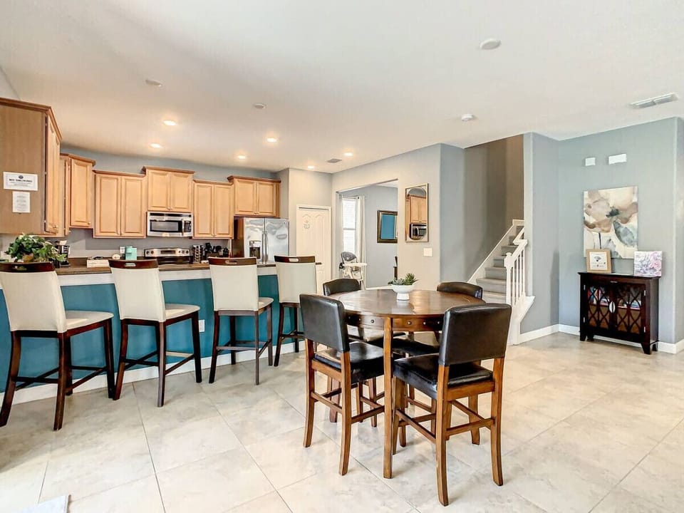 Cozy kitchen with a spacious counter, dining table, and seating for four, perfect for shared meals or morning coffee.