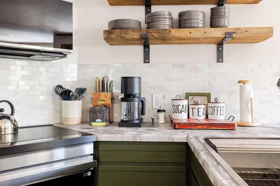 Kitchen is fully stocked with pasta, rice, flour, sugar, and spices