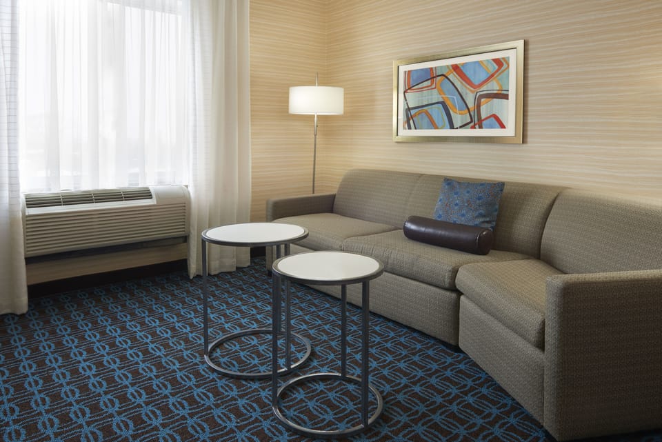 Suite, 1 King Bed with Sofa bed | Living area | 32-inch TV with satellite channels
