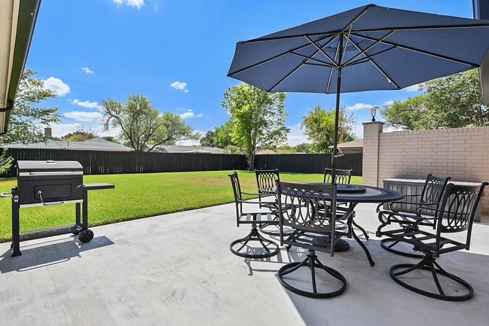 Large fenced in yard, charcoal grill and patio.