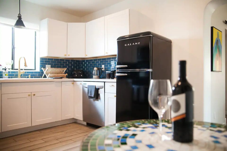 Retro fridge with bistro table—ideal for quick breakfasts or evening wine.