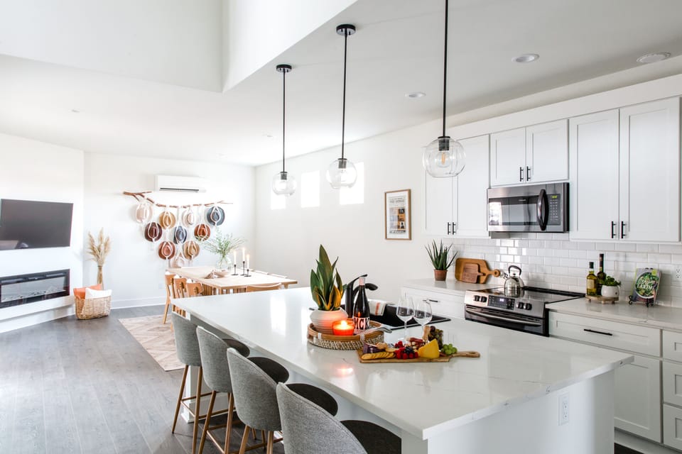 Light and bright open floor plan kitchen with bar seating for four people.