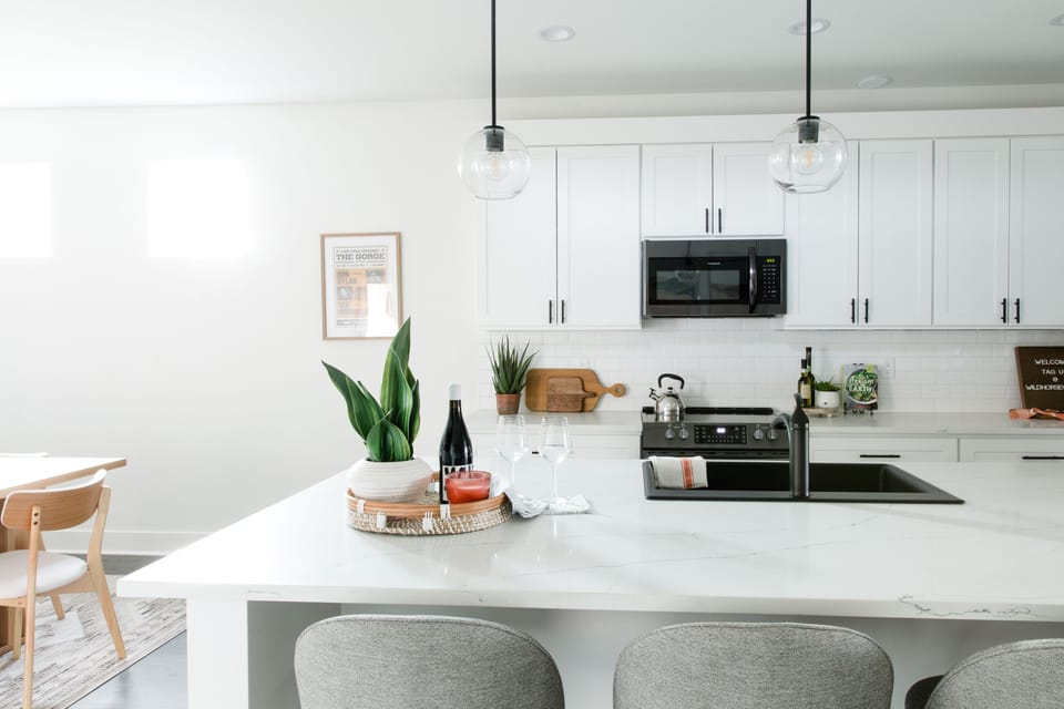 Kitchen is fully stocked with appliances, cookware, dishes, and cutlery.