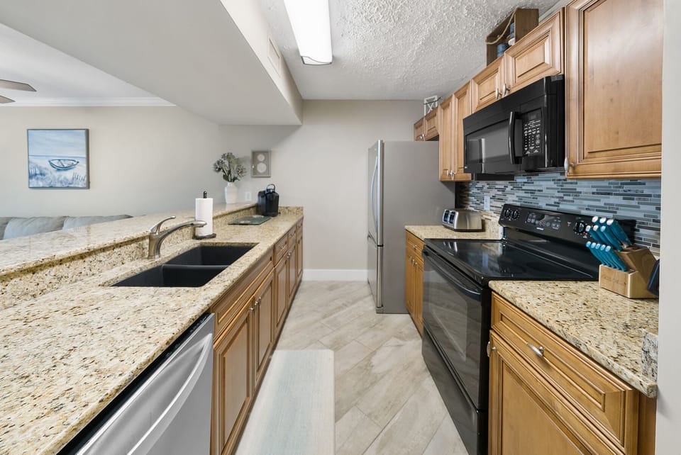 Your spacious kitchen features granite countertops, stainless steel appliances, and everything you need to prepare delicious meals during your stay.