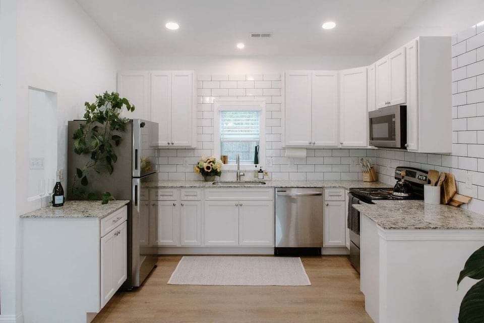 Modern kitchen featuring stainless steel appliances, granite countertops, and all the essentials needed for cooking meals during your Wilmington stay.