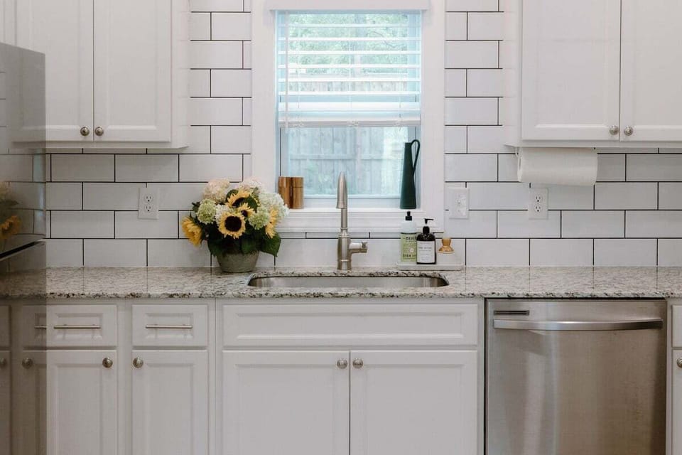 Modern kitchen featuring stainless steel appliances, granite countertops, and all the essentials needed for cooking meals during your Wilmington stay.