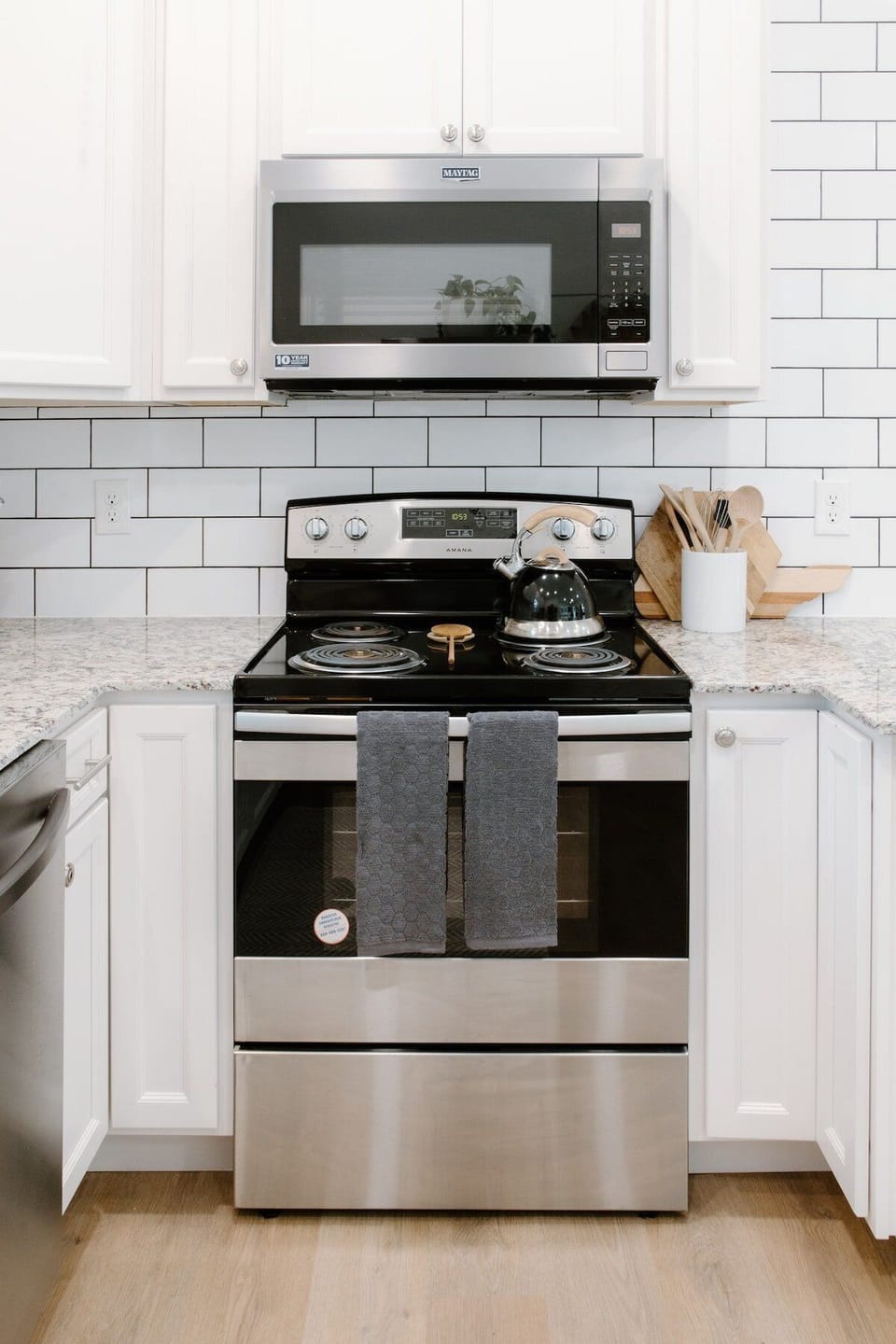 Modern kitchen featuring stainless steel appliances, granite countertops, and all the essentials needed for cooking meals during your Wilmington stay.