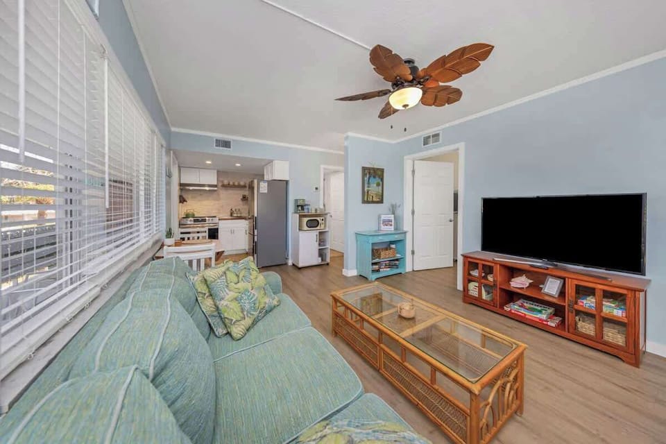 Open living room and kitchen with lots of beachy decor to get you in that island mood!