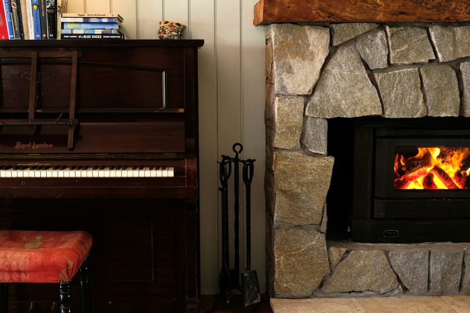Why not tickle the ivories by the fireplace?