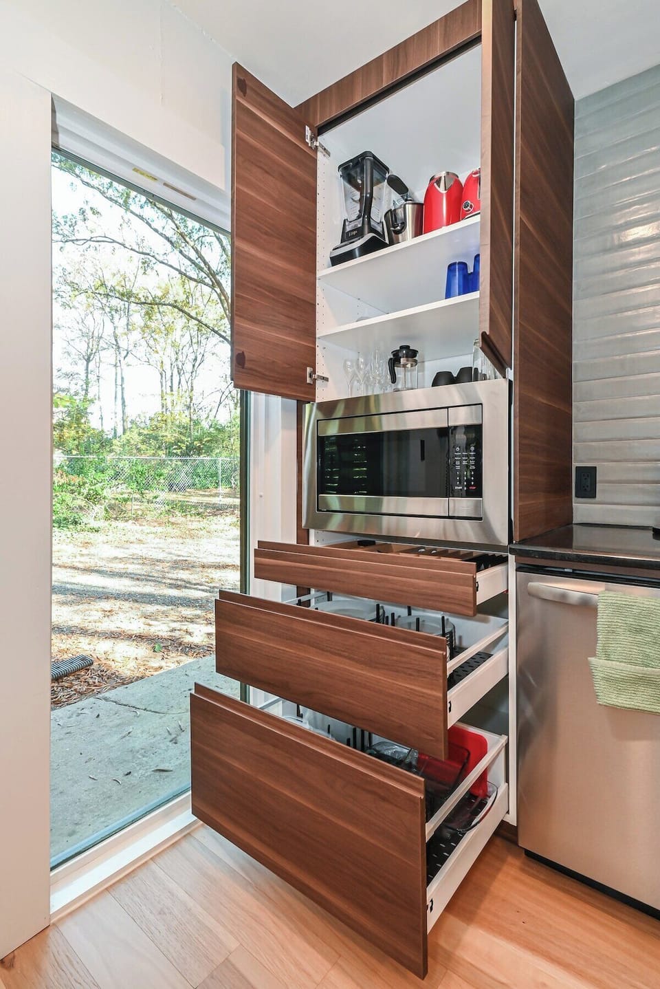 Every detail is covered—from utensils and plates to glassware and cookware, neatly tucked into custom cabinetry.