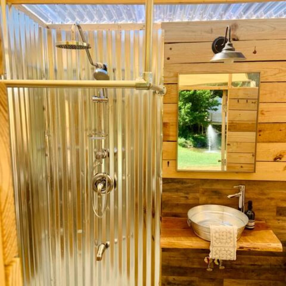 The shower has endless hot water, a rain head, normal head and body sprayer for the ultimate glamping shower