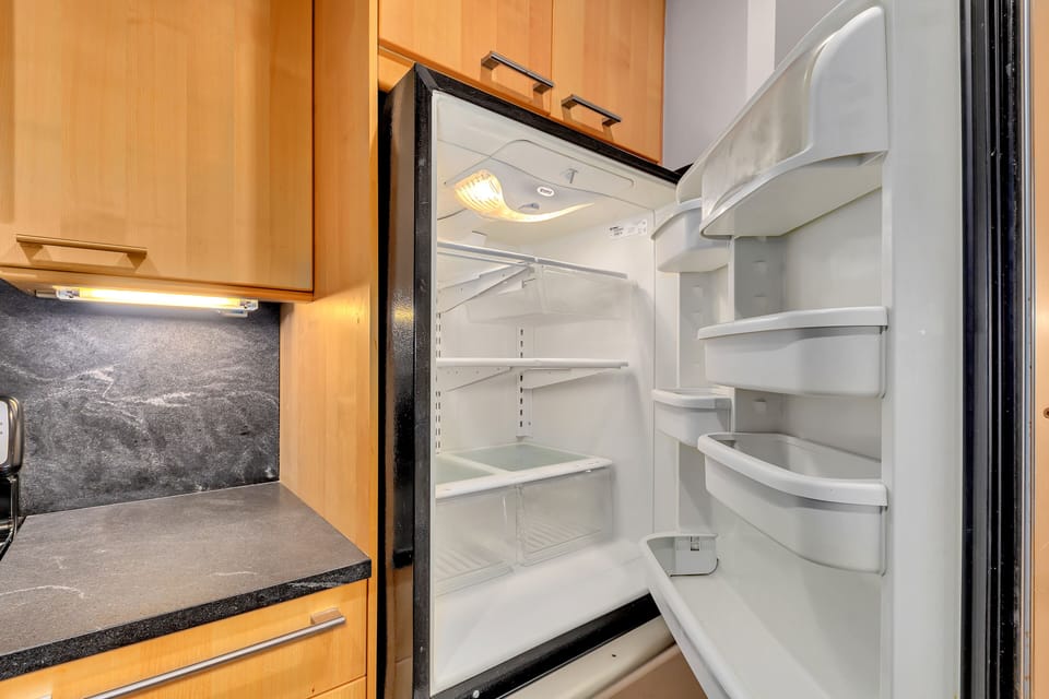 Open fridge interior w/ adjustable shelving for easy food storage