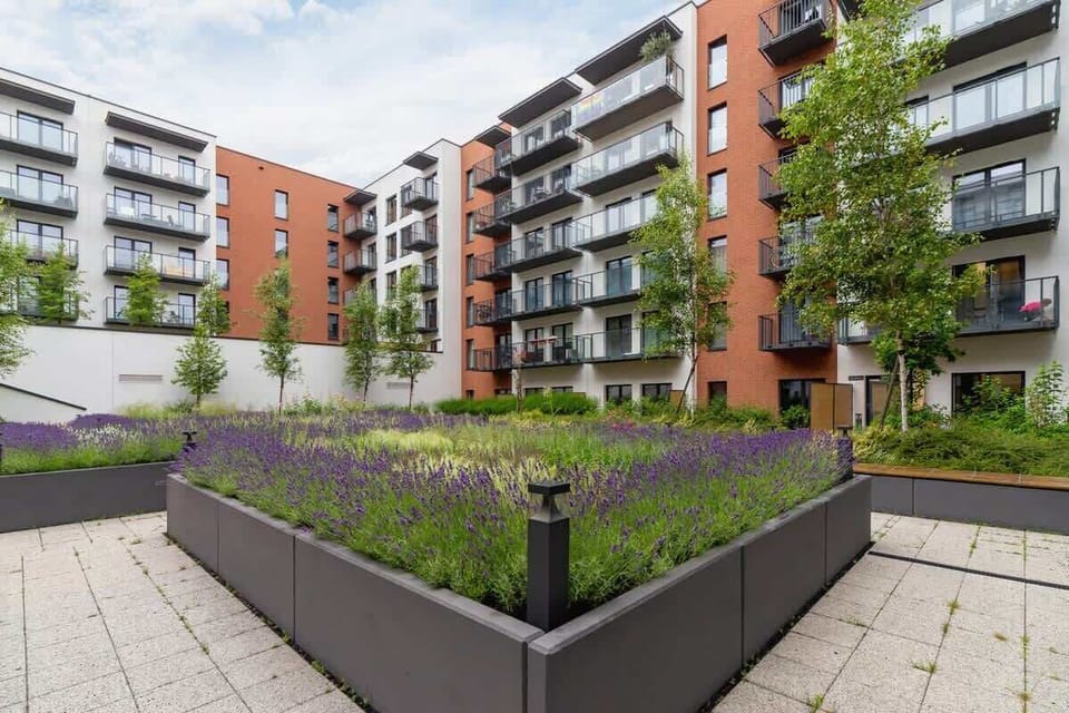 An outdoor courtyard within the residential complex, featuring greenery, planters, and a peaceful setting for residents.







