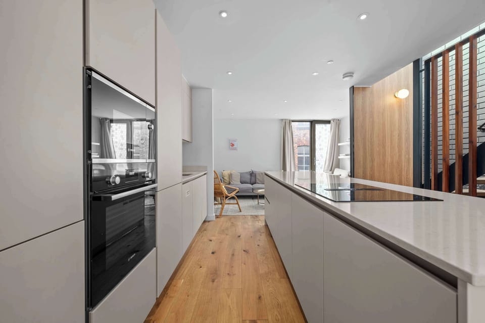 Sleek modern kitchen with integrated oven, hob and everything you need to cook at home