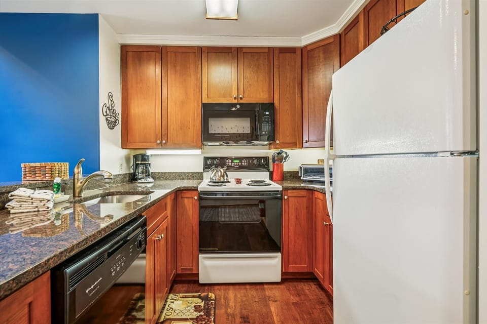Complete kitchen with stove, microwave, refrigerator, dishwasher, and all the cookware you'll need for your stay.