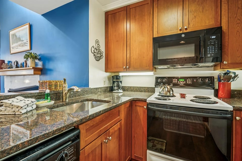 Bright and functional kitchen featuring ample cabinet space, coffee maker, and modern appliances.