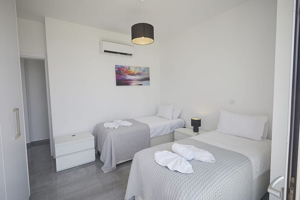 Bedroom 3 with two single beds that can be made into a double and balcony access