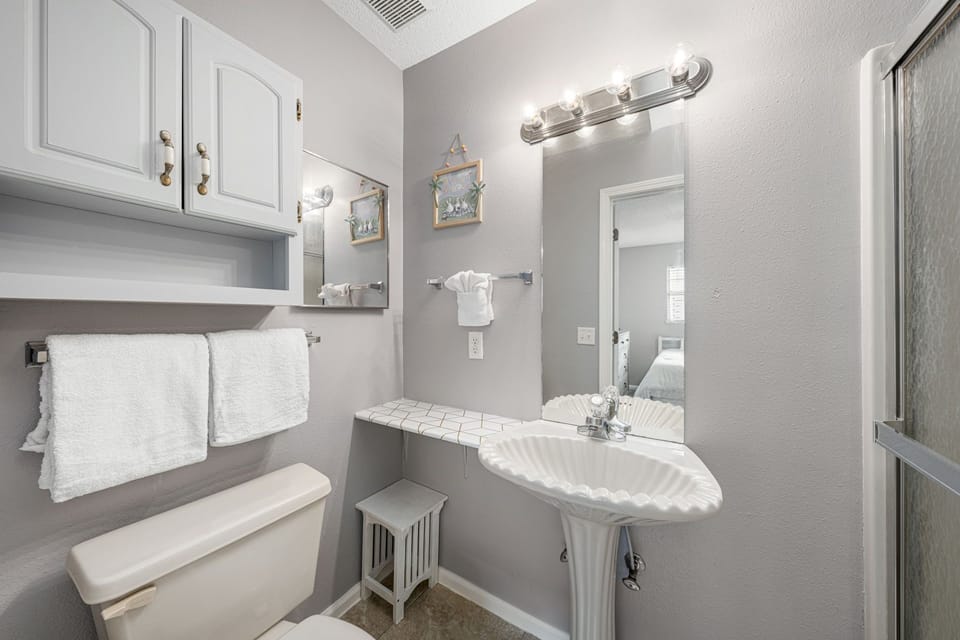 modern bathroom with a scalloped sink and ample lighting