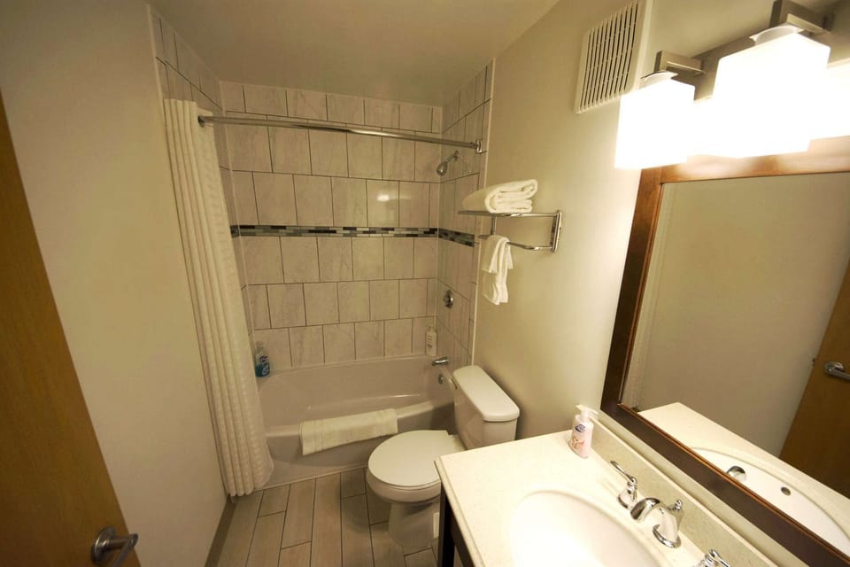 Bathroom with bathtub, shower, sink and towels
