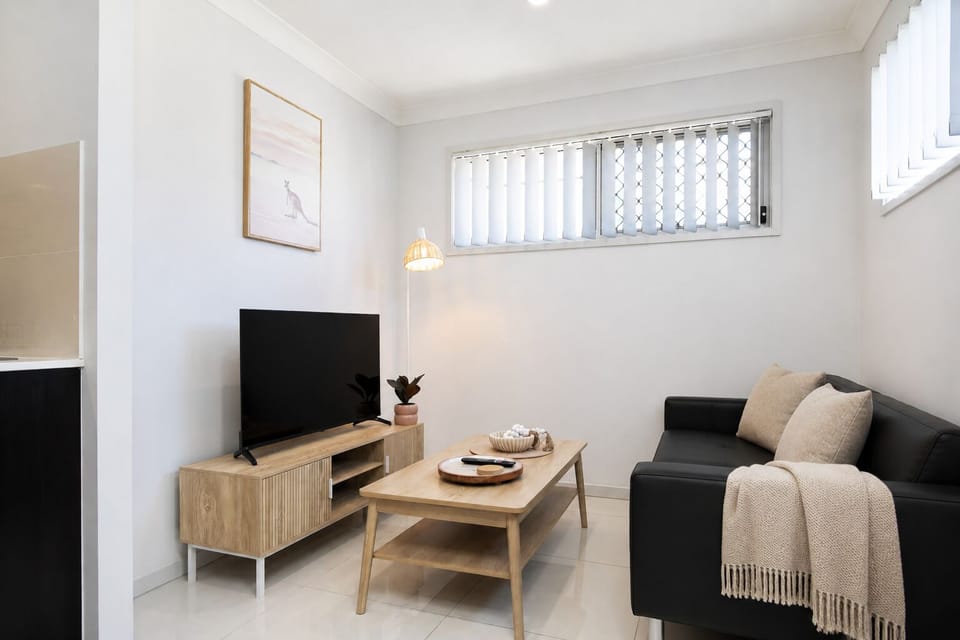 Living Area: Bright living space with comfortable seating and TV