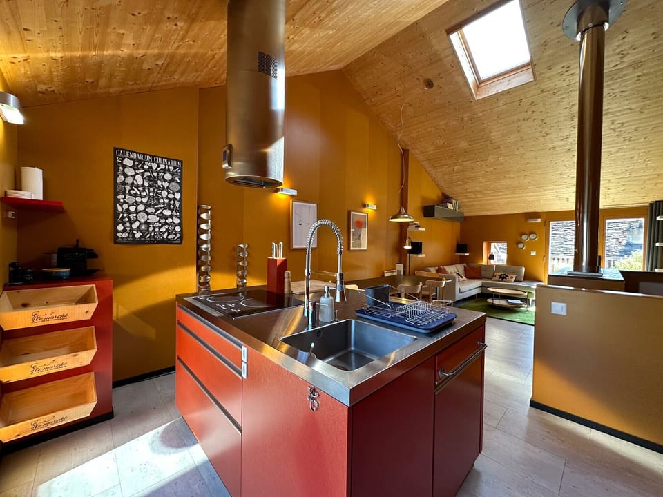 Fully fitted and equipped kitchen opening onto the living room, offering a bright and friendly space