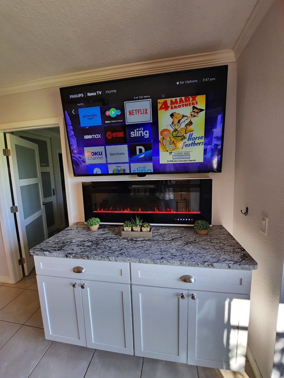 Entertainment Center with 65"streaming HD TV and glass fireplace.