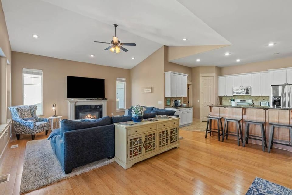 Kitchen with bar stools, and TV sitting area