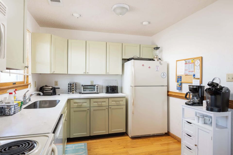 Top Level: Fully stocked kitchen with refrigerator, oven, microwave, dishwasher, Keurig, blender, toaster oven, traditional 2-slice toaster, kettle, waffle maker and ample storage cabinet