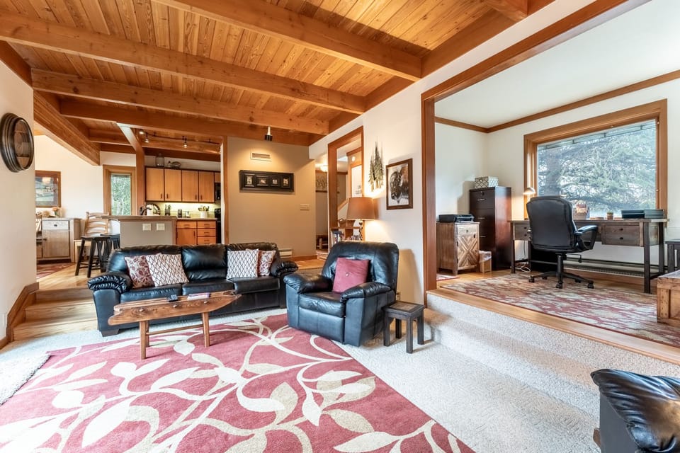 Recessed living area with ample seating, a flatscreen TV, gas fireplace, and access to the private balcony.