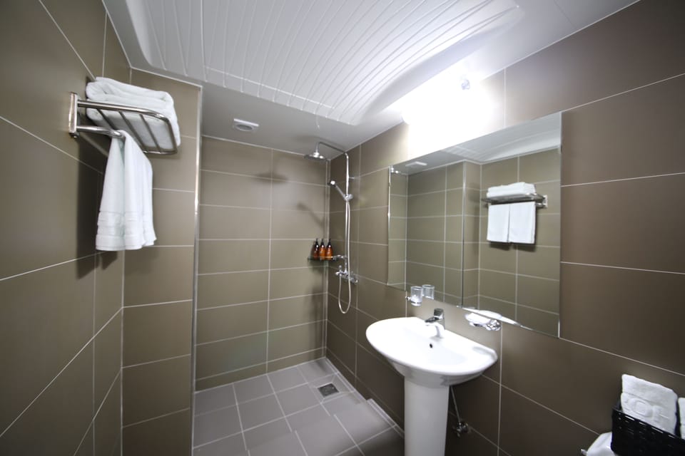 Shower, hair dryer, slippers, towels
