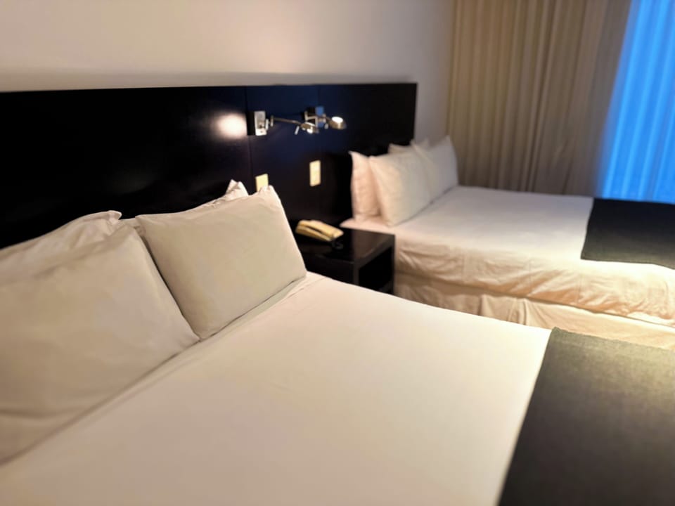 Deluxe Quadruple Room, 2 Queen Beds | In-room safe, free WiFi