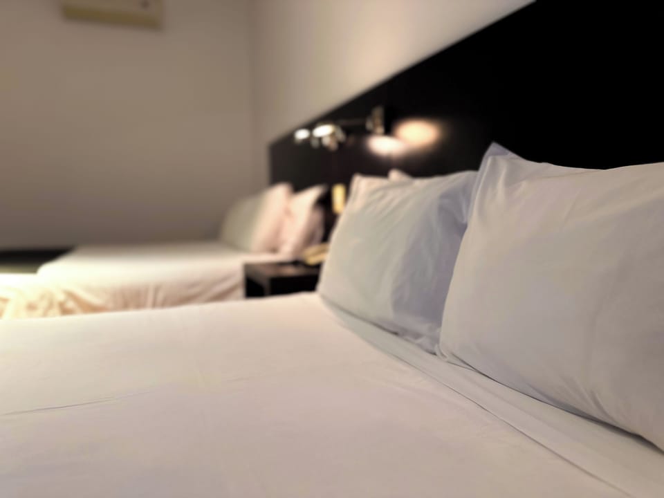 Deluxe Quadruple Room, 2 Queen Beds | In-room safe, free WiFi