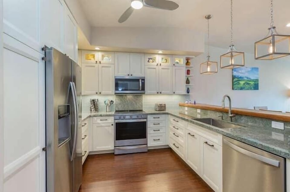 State-of-the-art kitchen complete with granite counter tops, stainless steel appliances and custom cabinetry. 