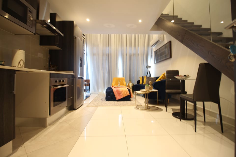 Deluxe Duplex | Living area | Flat-screen TV