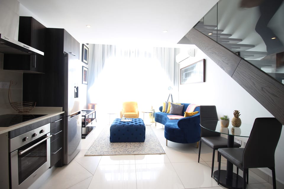 Deluxe Duplex | Living area | Flat-screen TV