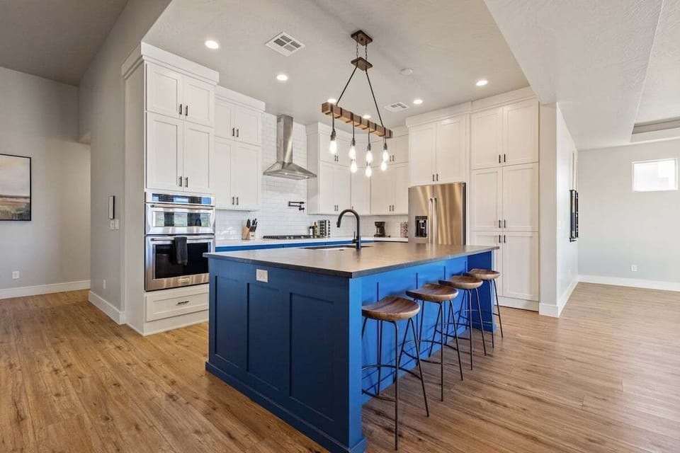 Barstool seating at the island provides space for casual conversation, welcoming family and friends to gather around.