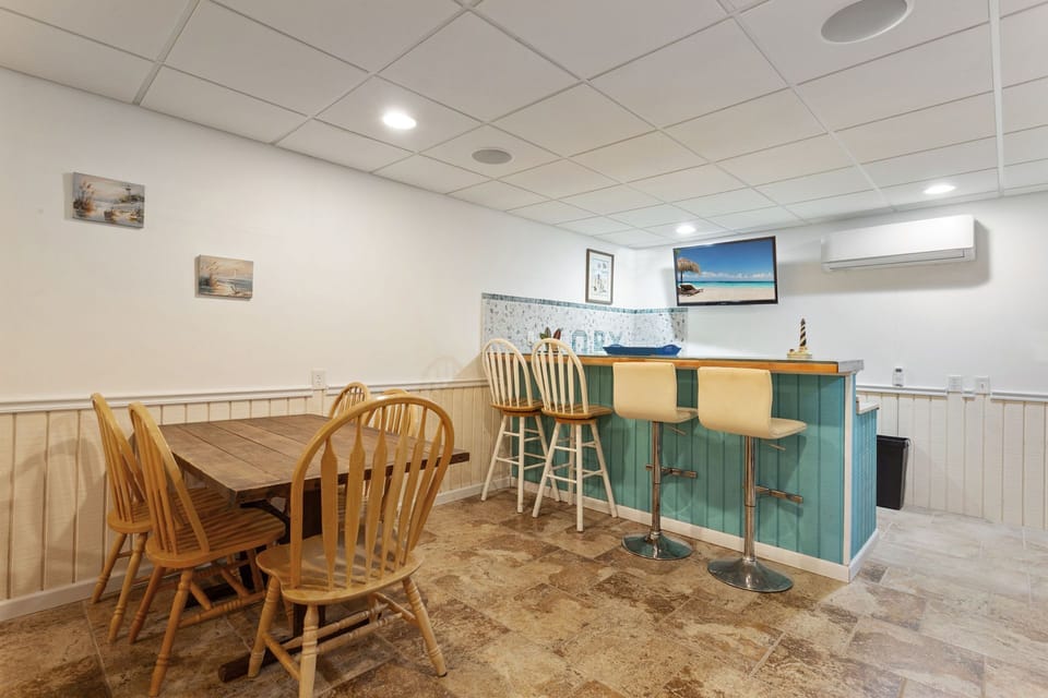 The Lower-Level Entertainment Area boasts a Card Table, Wet Bat, and Queen Sleeper Sofa.