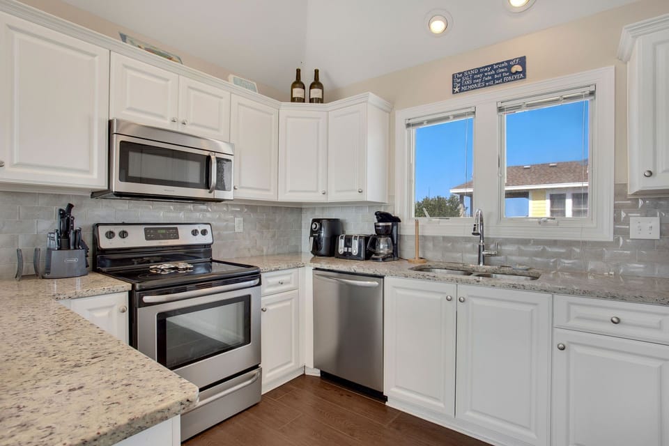 Whip up something delicious in the Open Kitchen with Modern Appliances!